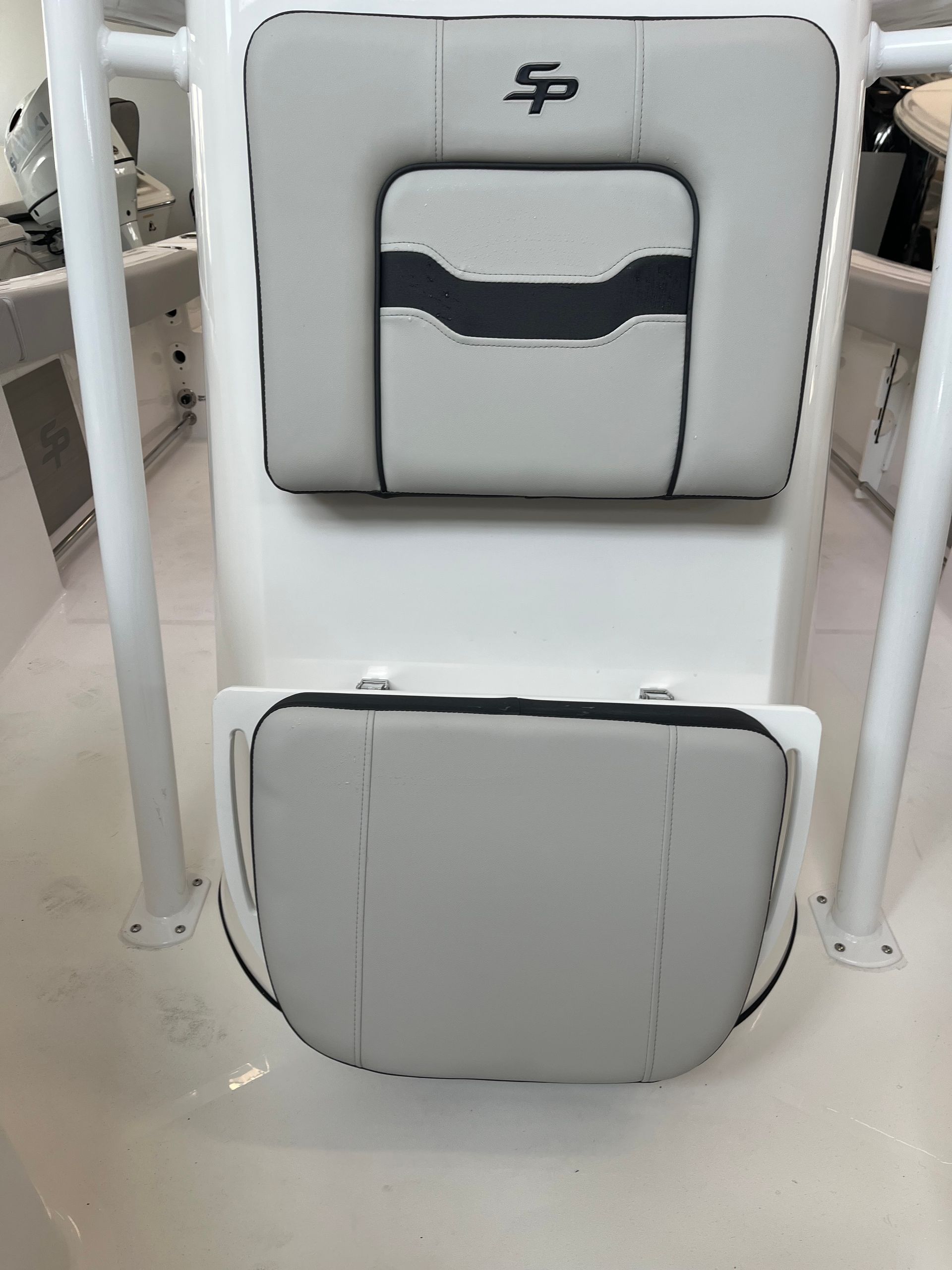 A close up of a boat seat with a black stripe on it.