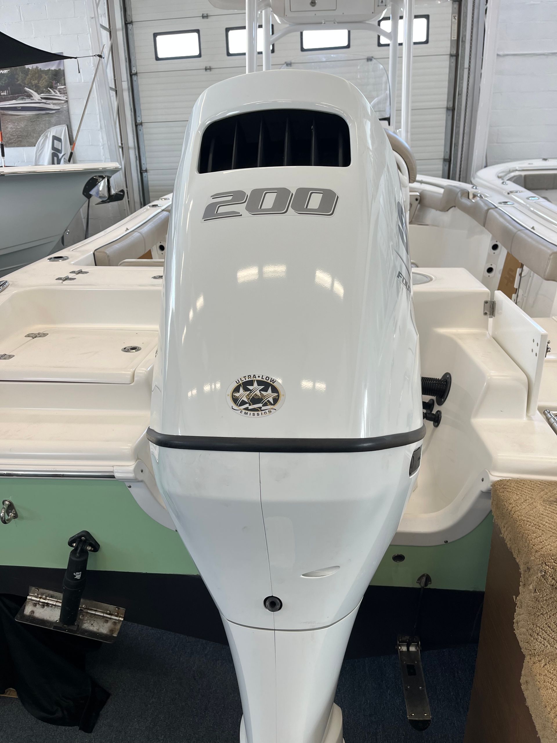 White outboard motor on a boat with the number 200 visible.