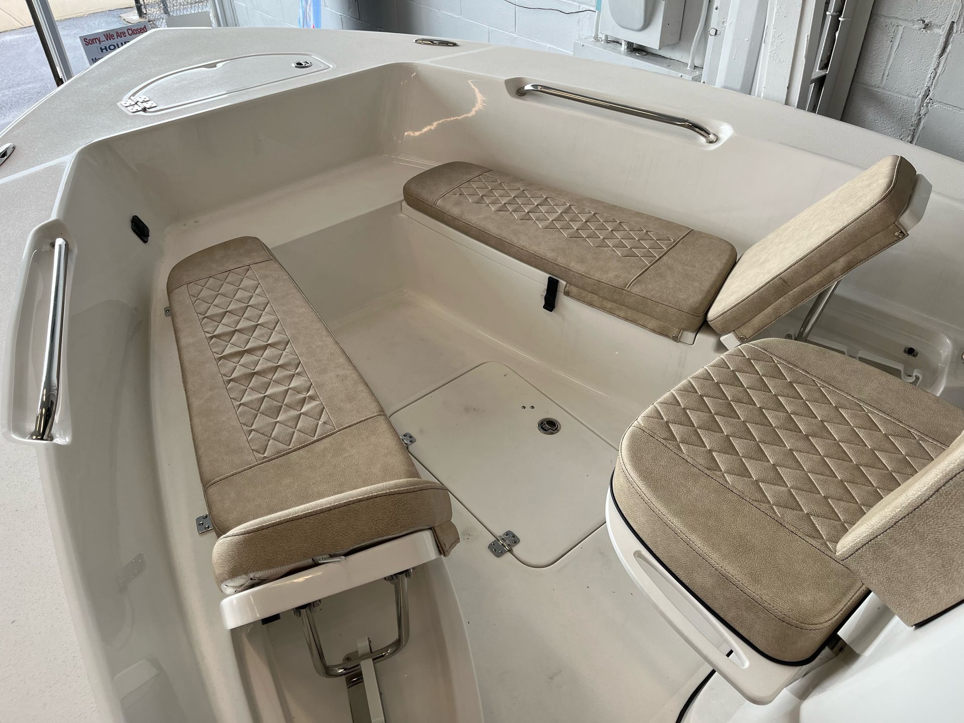 The inside of a boat with two seats and a bench