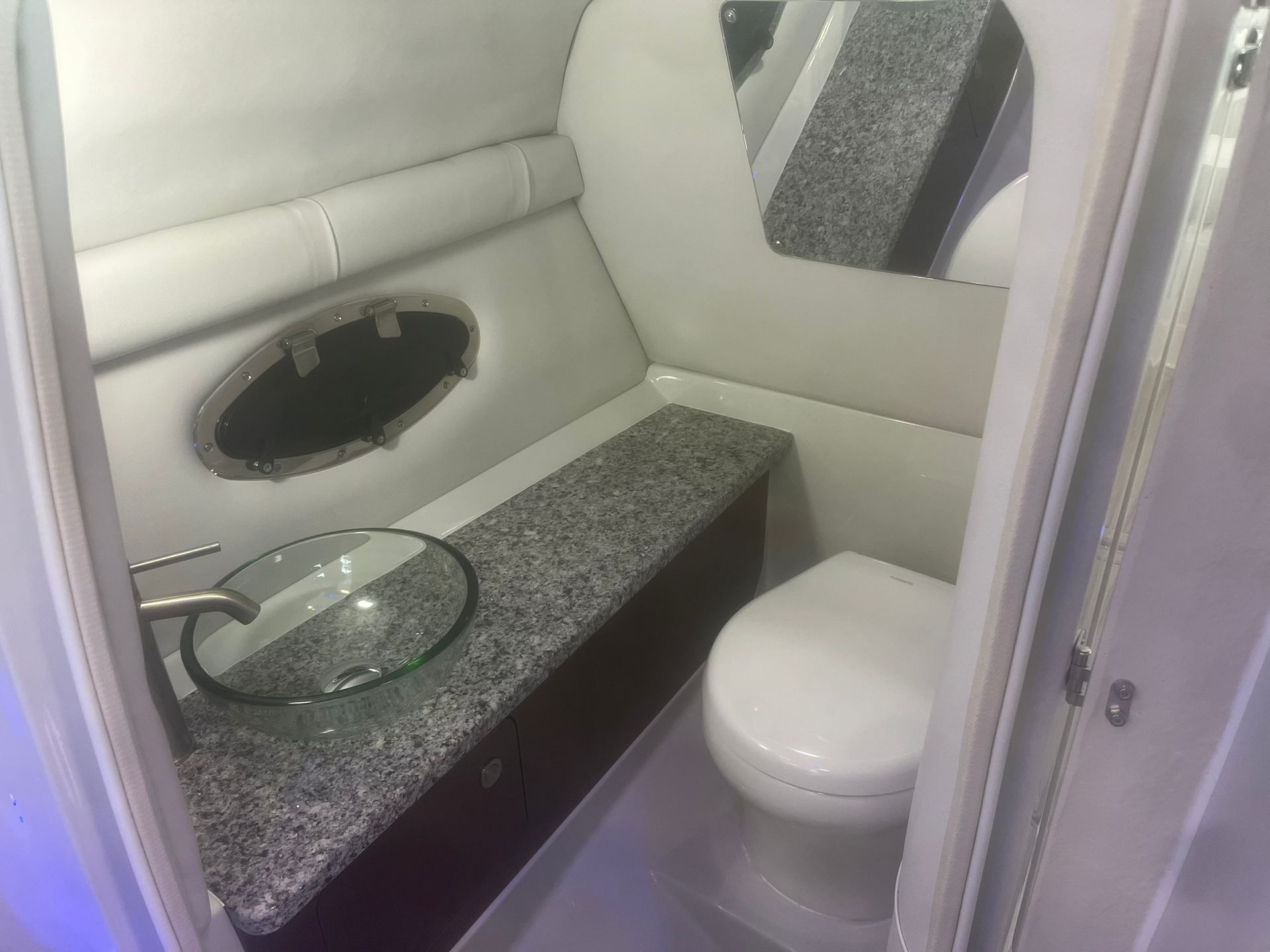 A bathroom on a boat with a sink and toilet