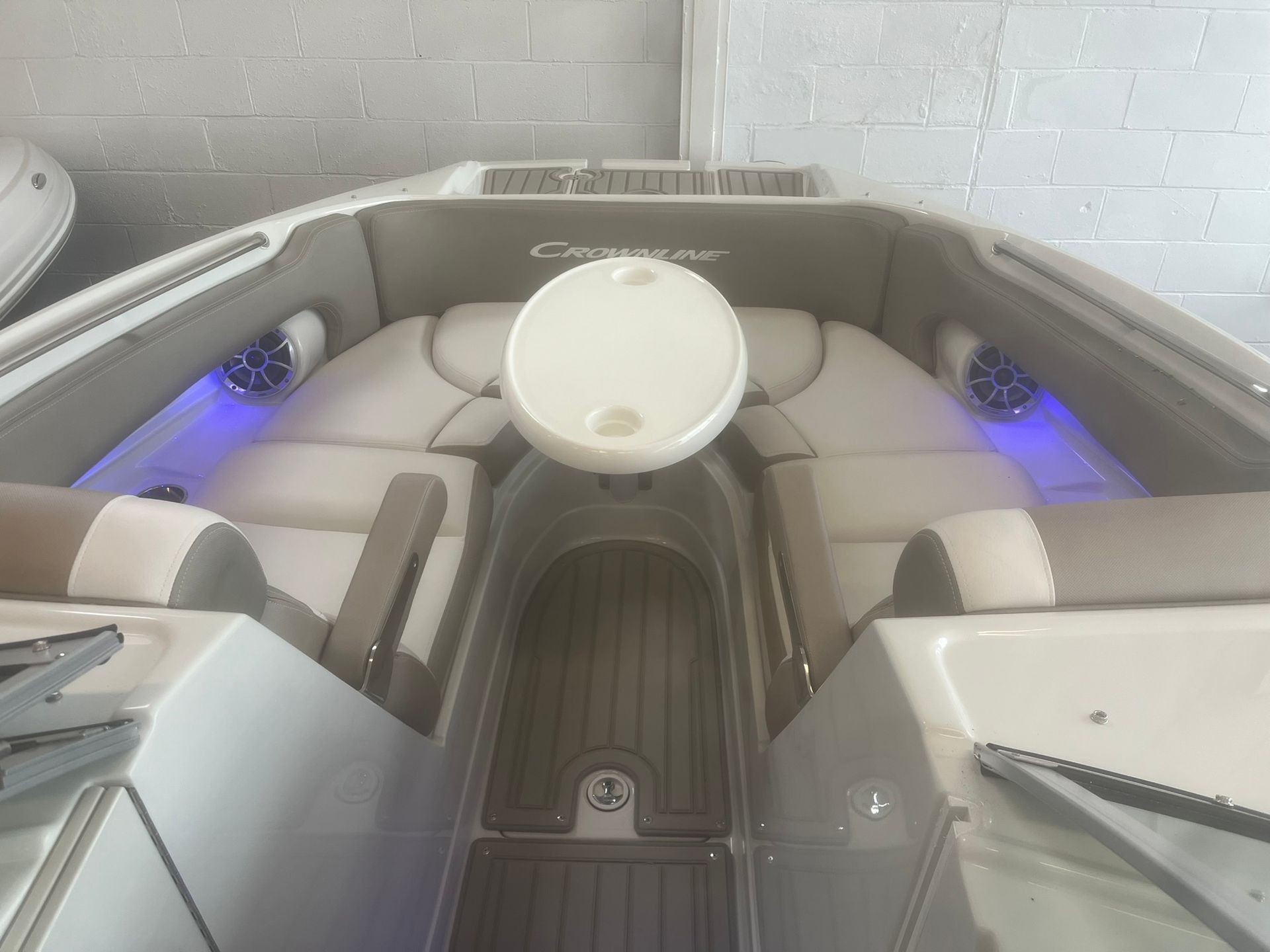 The inside of a boat with a table and speakers