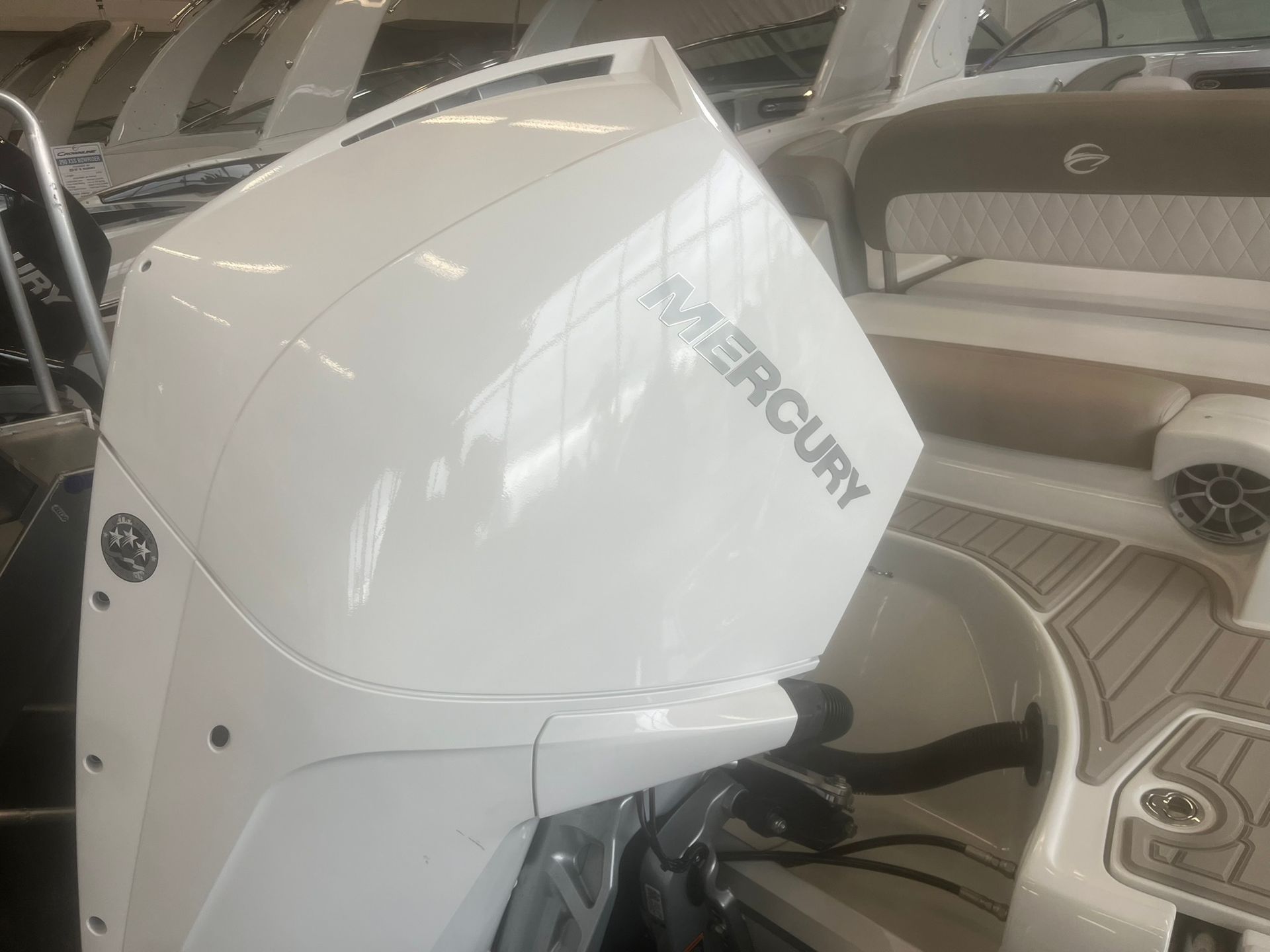 A white mercury outboard motor is sitting on top of a boat