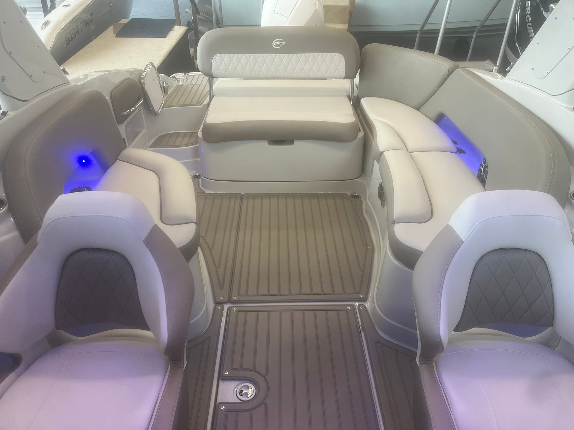 The inside of a boat with a couch and chairs