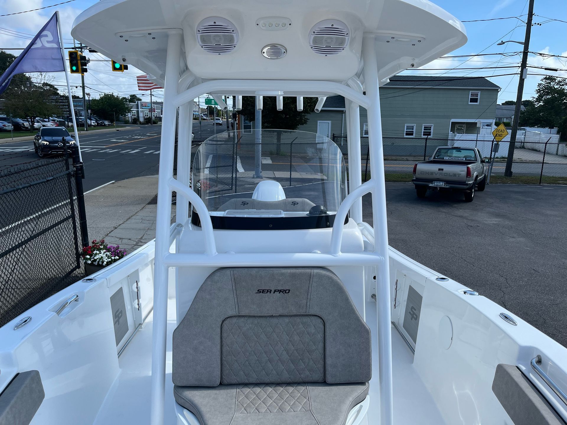 A white boat is parked on the side of the road