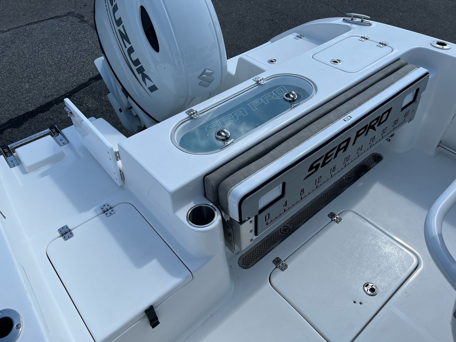 A white boat with a suzuki outboard motor on the back