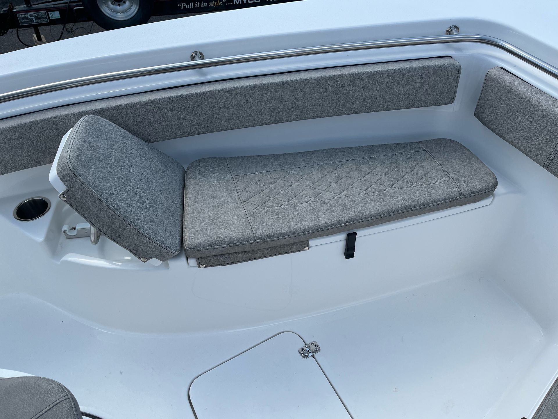 A white boat with a gray seat