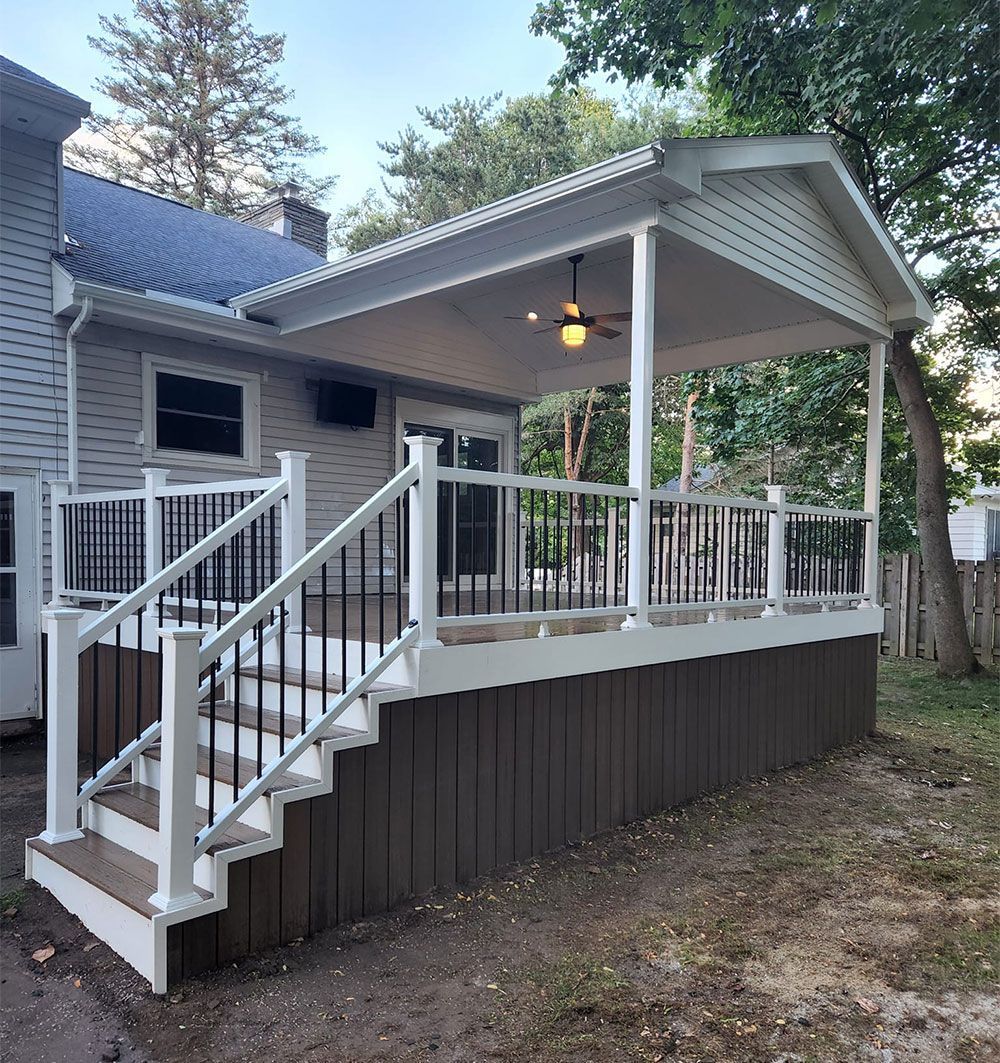 A house with a porch and stairs leading up to it.