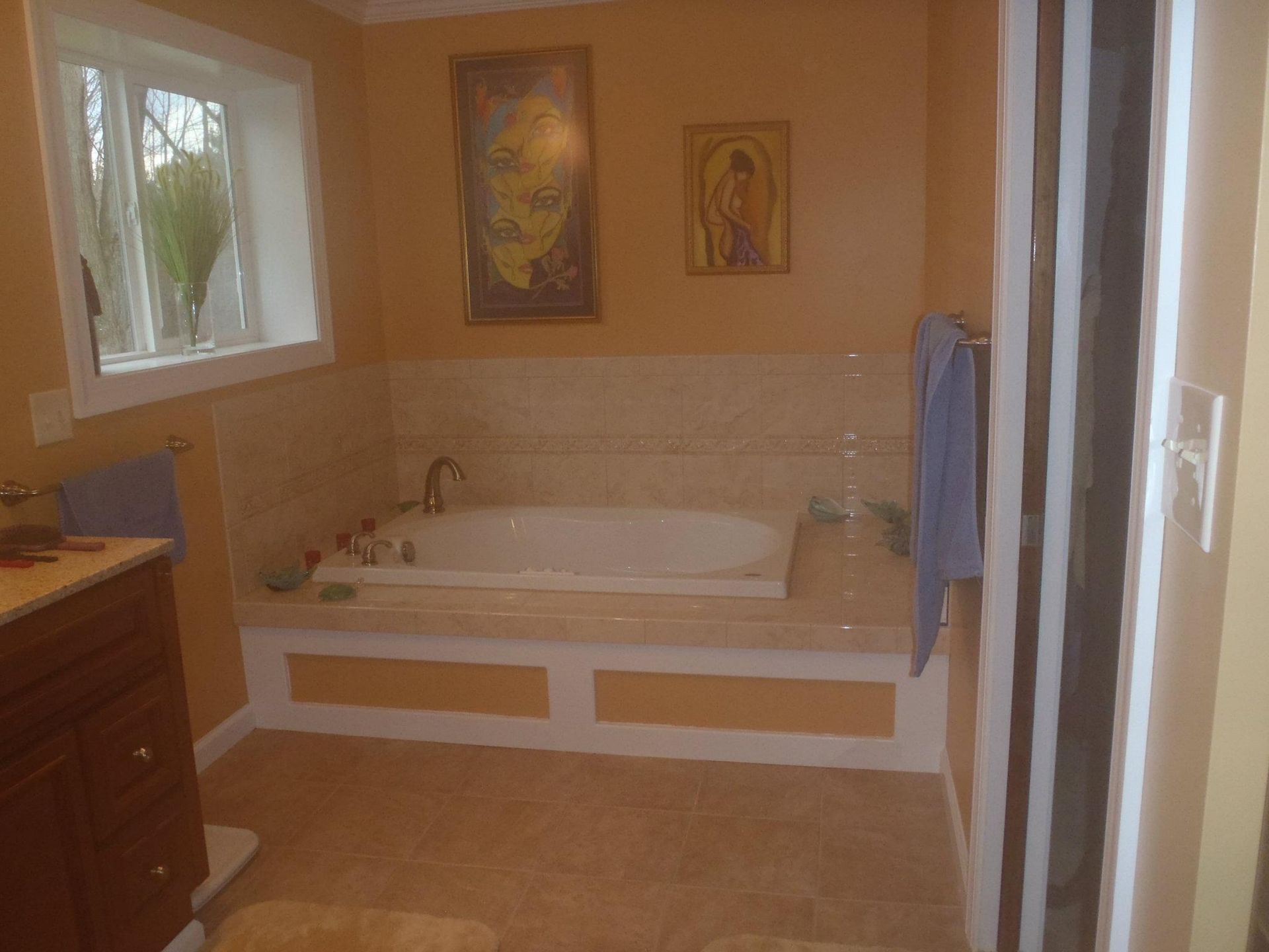 A bathroom with a bathtub and a window