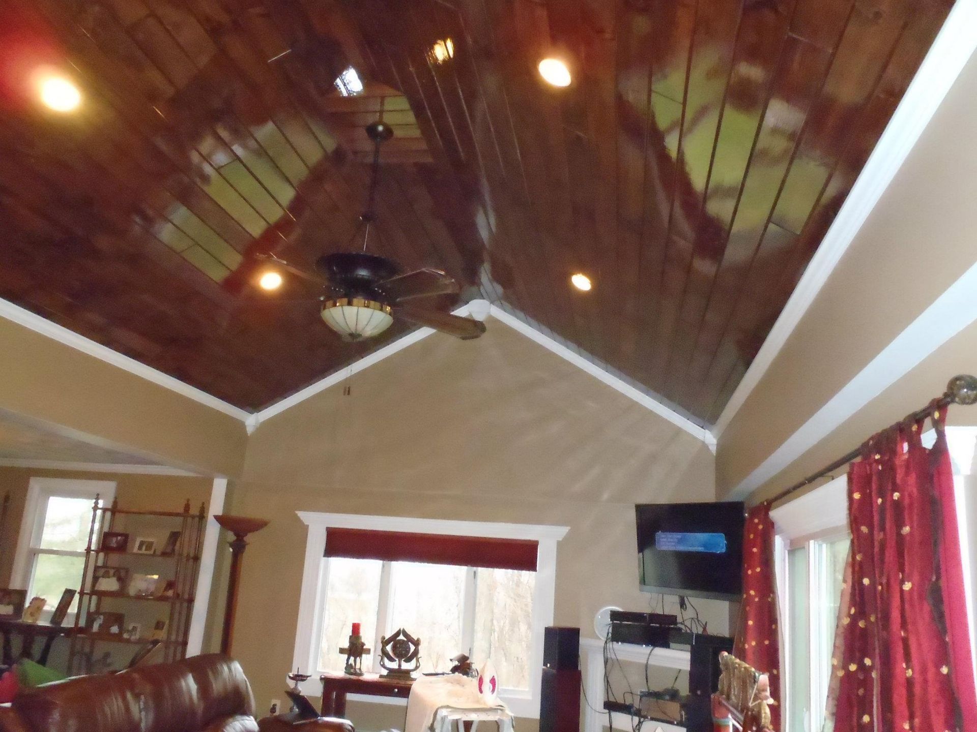 A living room with a vaulted ceiling and a ceiling fan