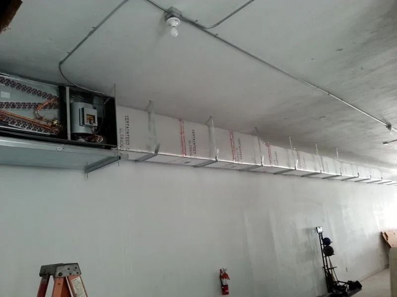 HVAC system components, including ductwork, installed near the ceiling of an interior room.