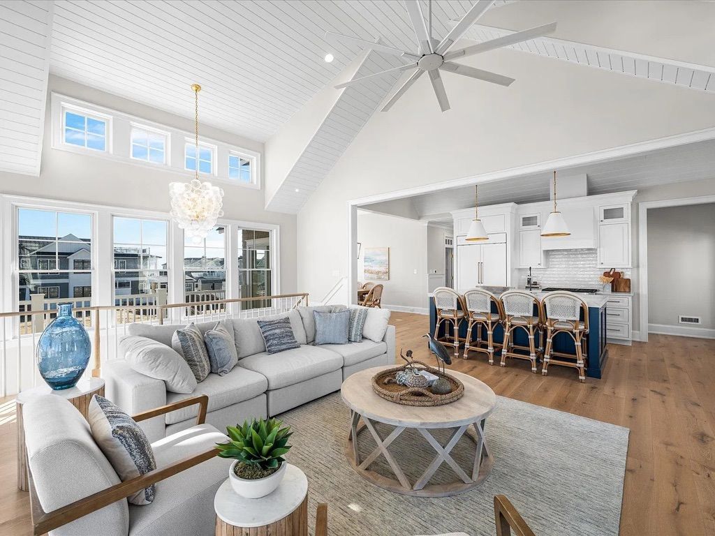 A living room filled with furniture and a ceiling fan.