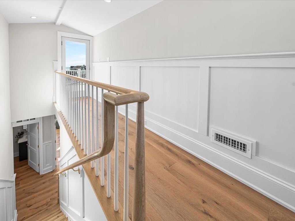 A hallway with stairs leading up to the second floor of a house.
