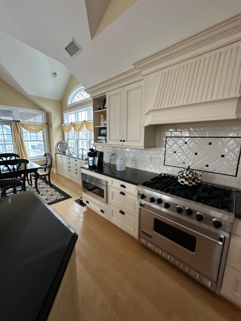 A kitchen with stainless steel appliances and white cabinets