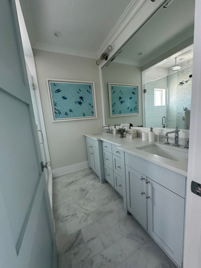 A bathroom with two sinks and a large mirror