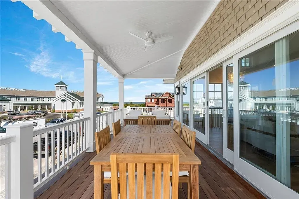 A large deck with a table and chairs on it