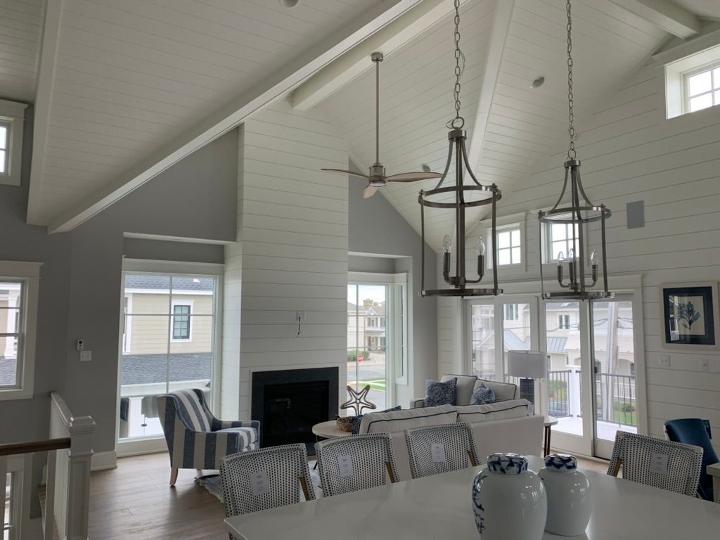 A living room with a vaulted ceiling and a fireplace