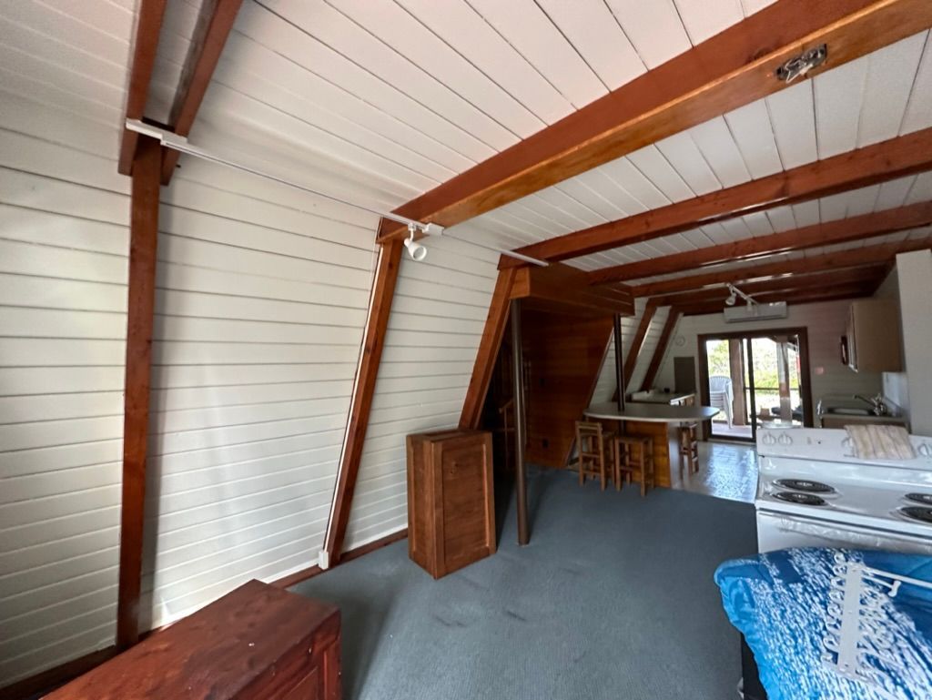 An empty room with a stove and a dresser