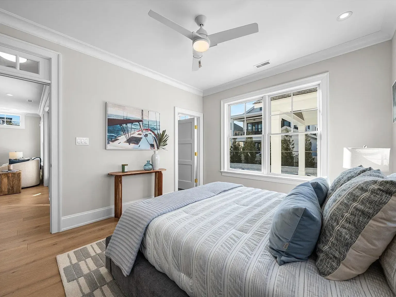 A bedroom with a large bed and a ceiling fan.