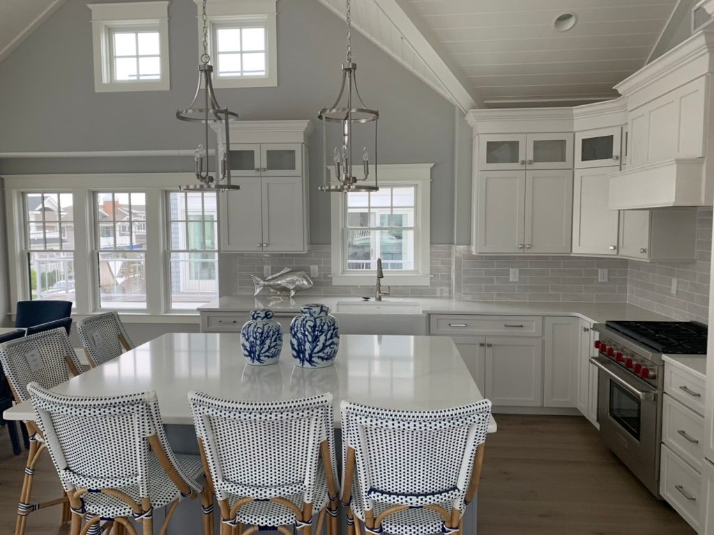 A kitchen with a table and chairs and a stove.