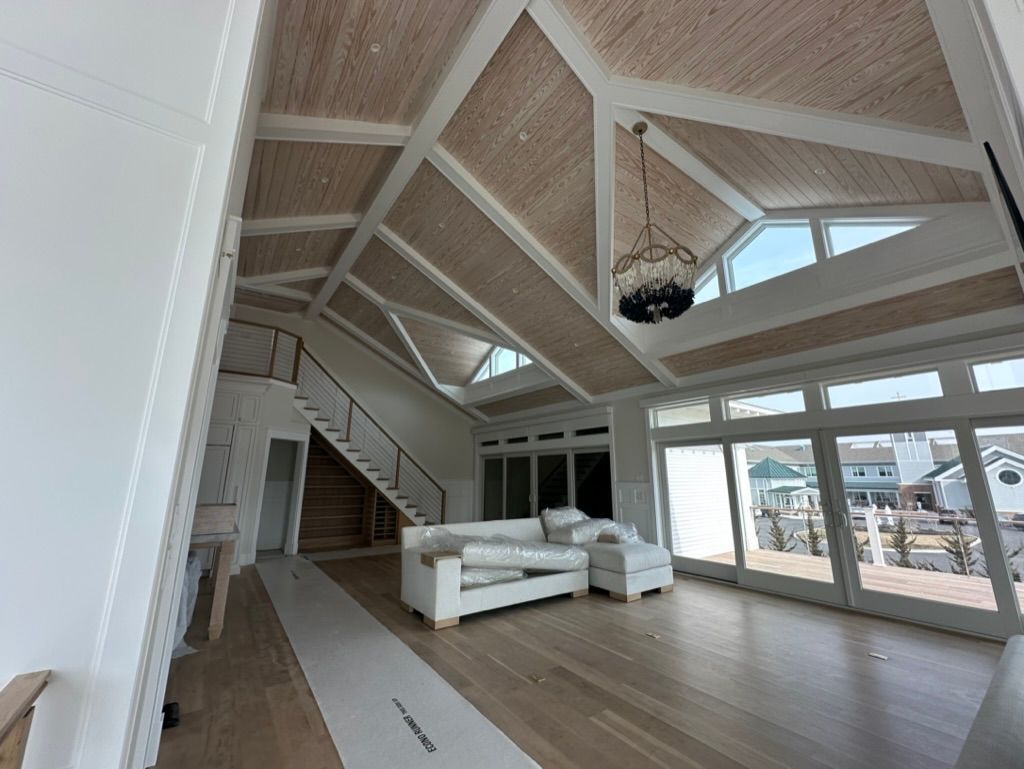 A living room with a vaulted ceiling and lots of windows