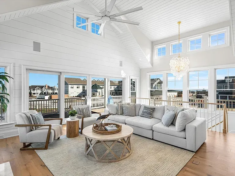 A living room filled with furniture and a ceiling fan.