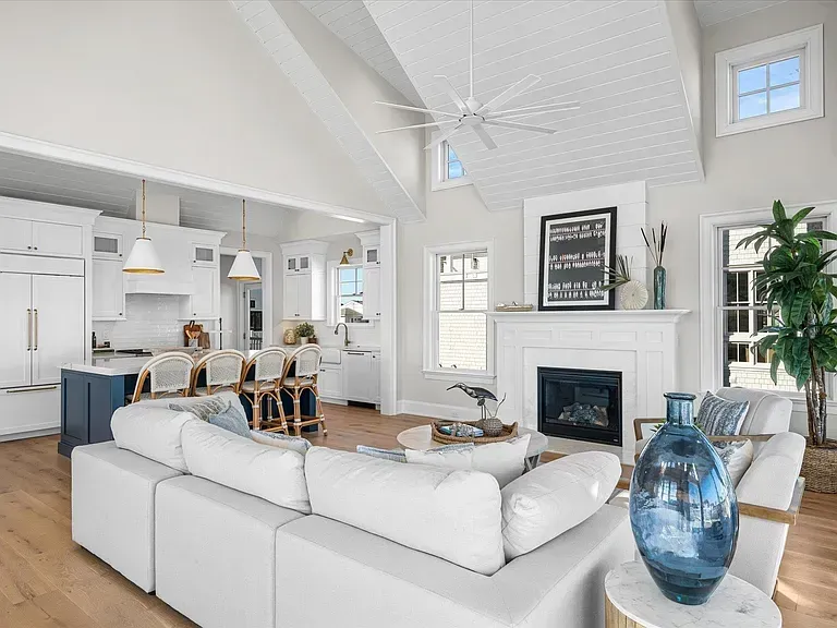 A living room filled with furniture and a fireplace in a house.
