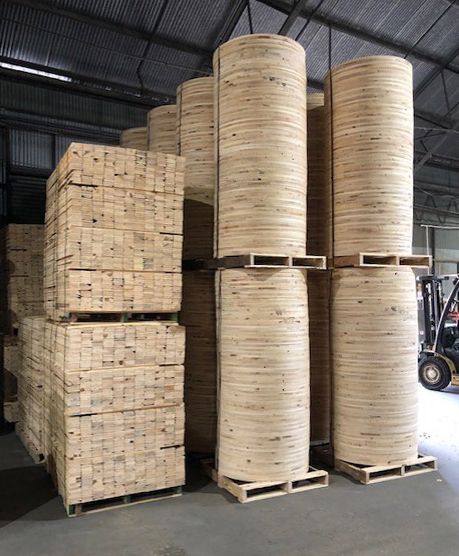 A warehouse filled with lots of wooden reels stacked on top of each other