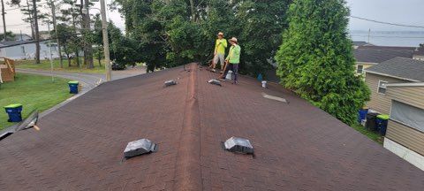 Two workers on a roof