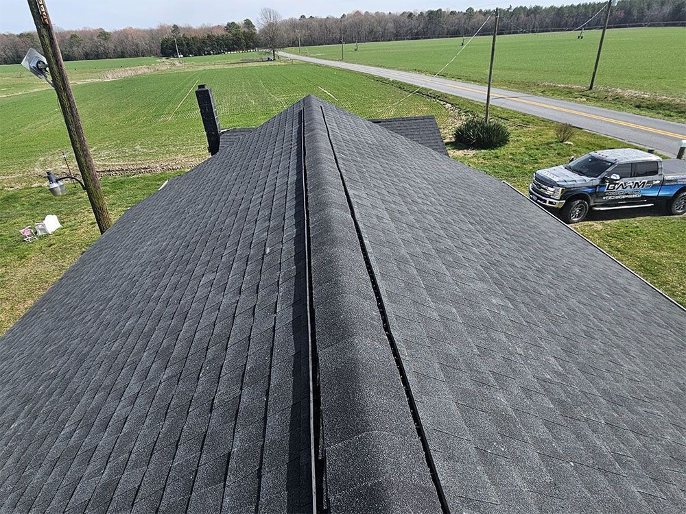 An aerial view of a roof with a truck parked on the side of the road