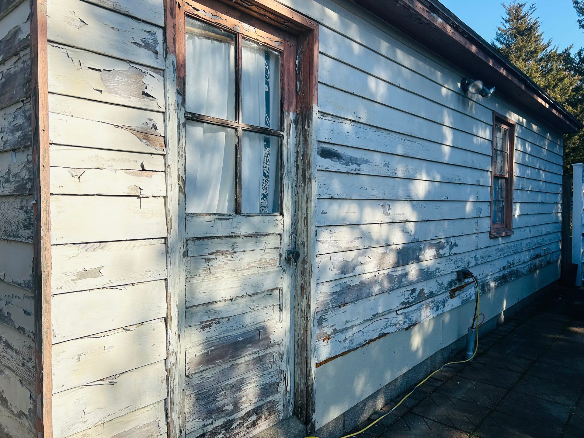 A white house with a blue door and a window