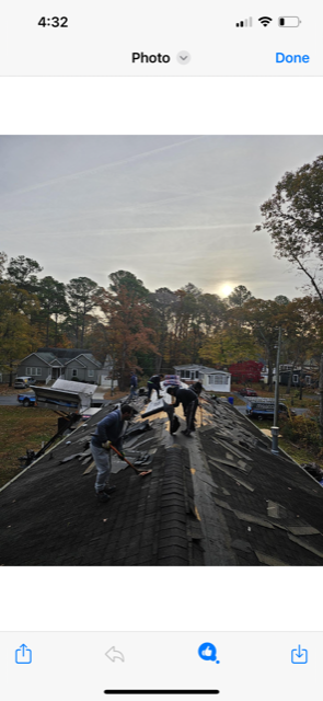 A group of people are working on a roof.