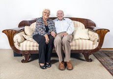 two old couple sitting in sofa