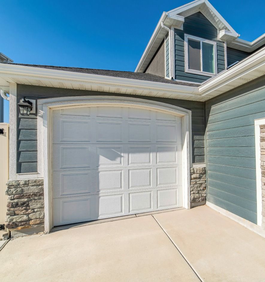 A house with a white garage door and a blue siding