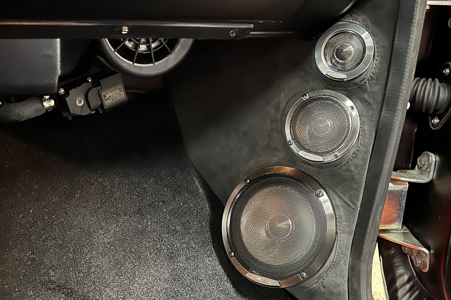 A close up of three speakers in a car