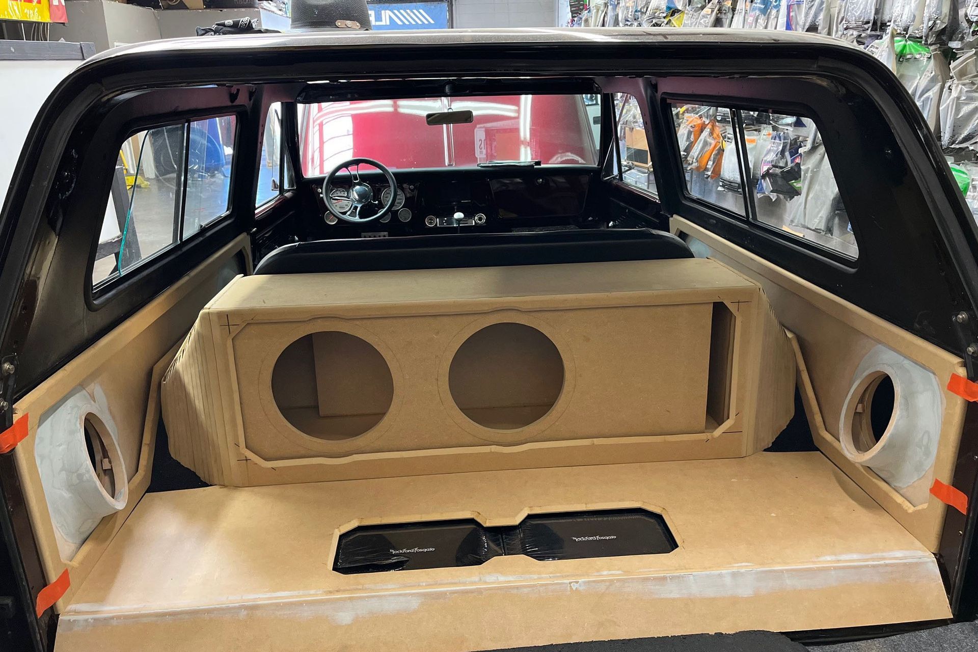 The back of a car with a wooden box in it.