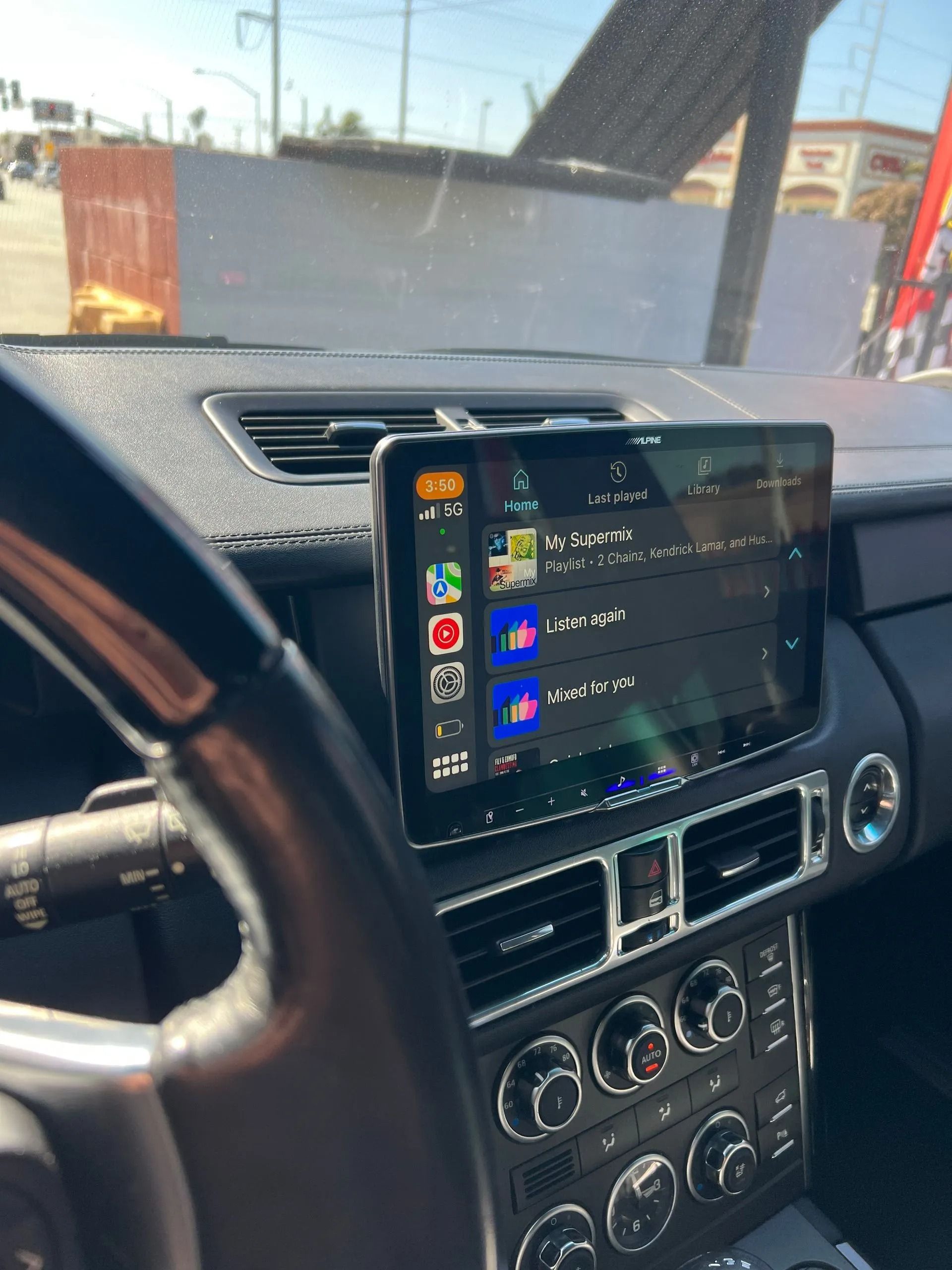 The dashboard of a range rover with a tablet on it.