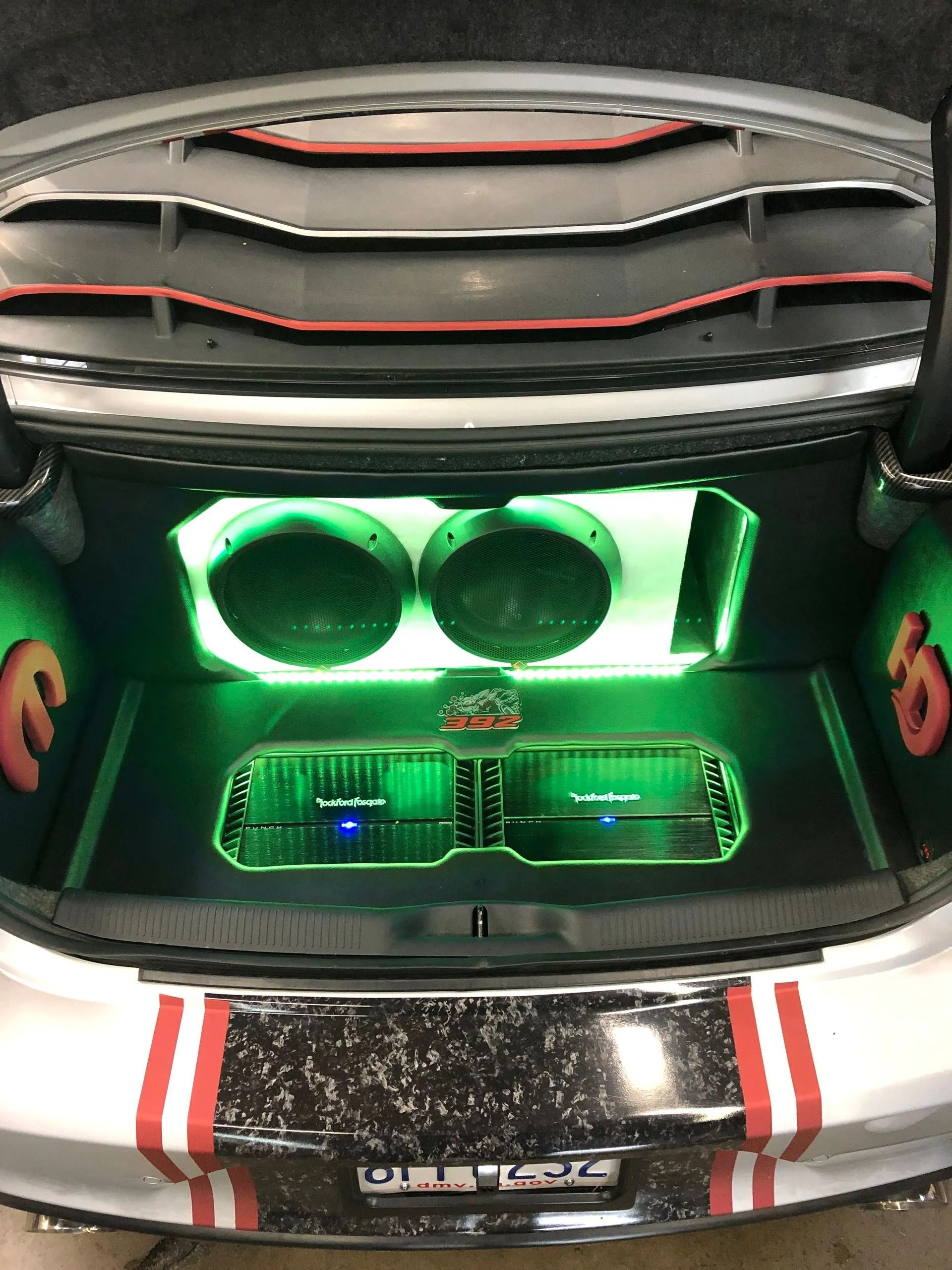 A pair of speakers are sitting in the back of a car.