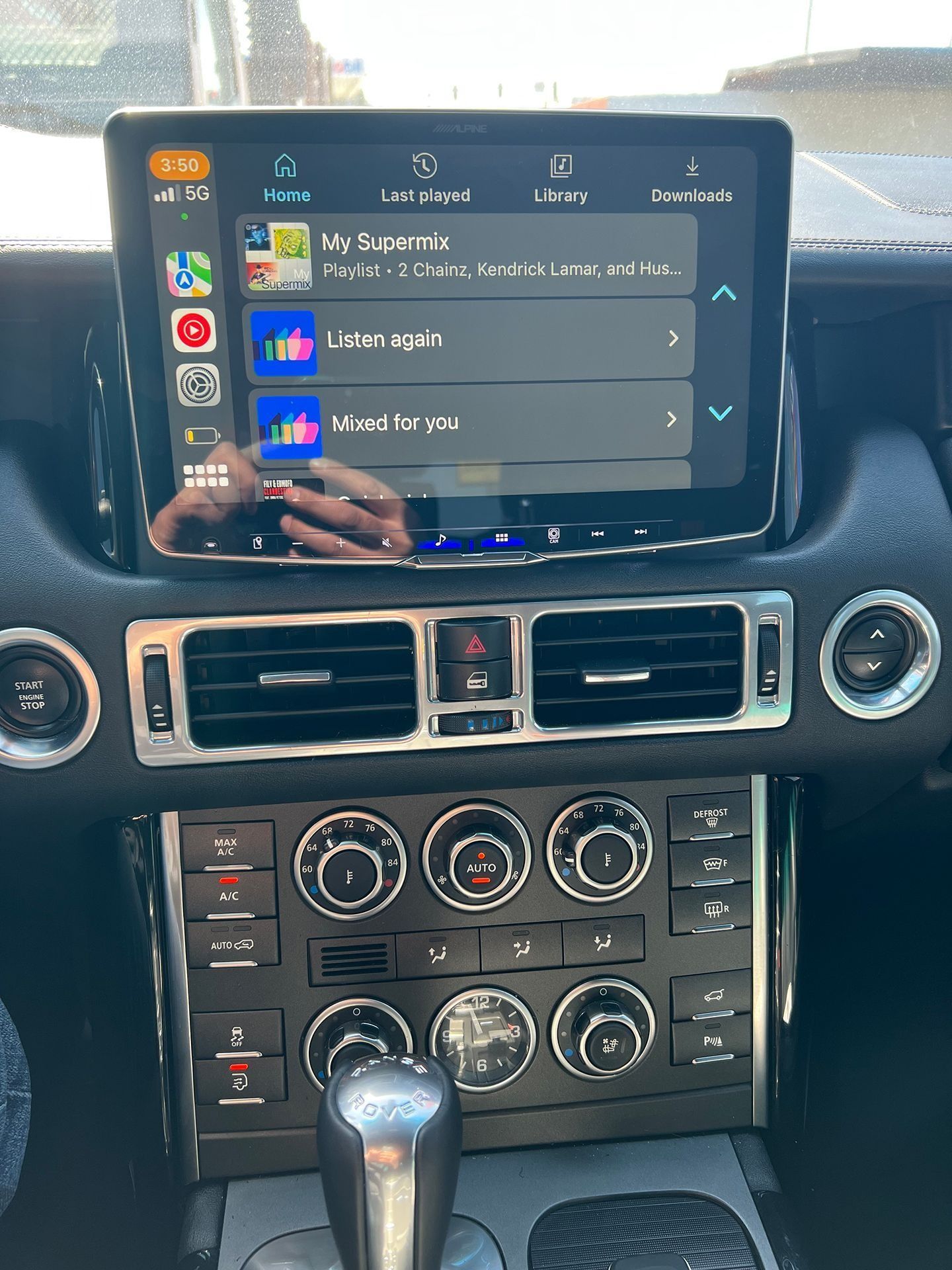 The inside of a car with a tablet on the dashboard