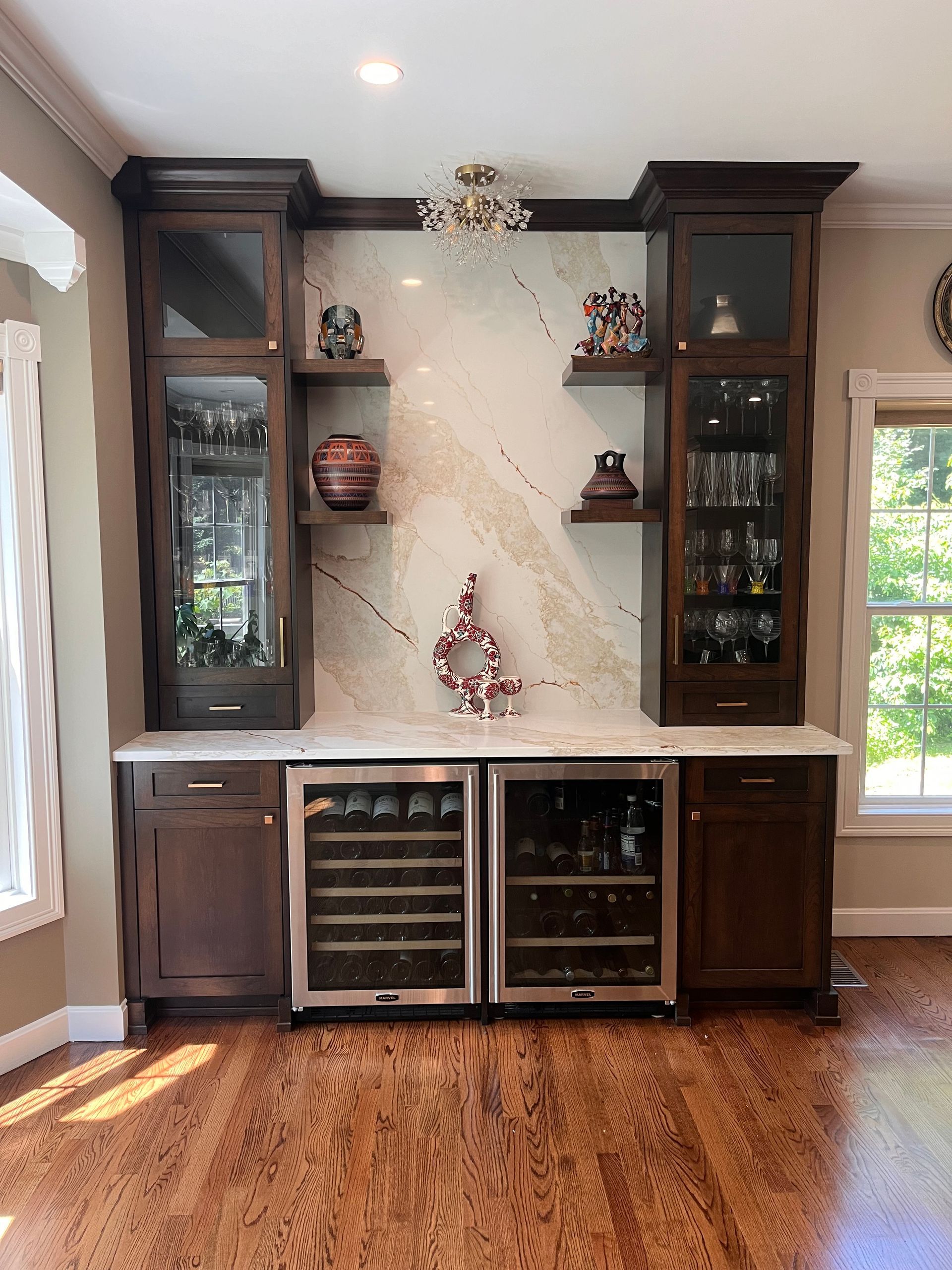 There is a wine cooler in the middle of the room.