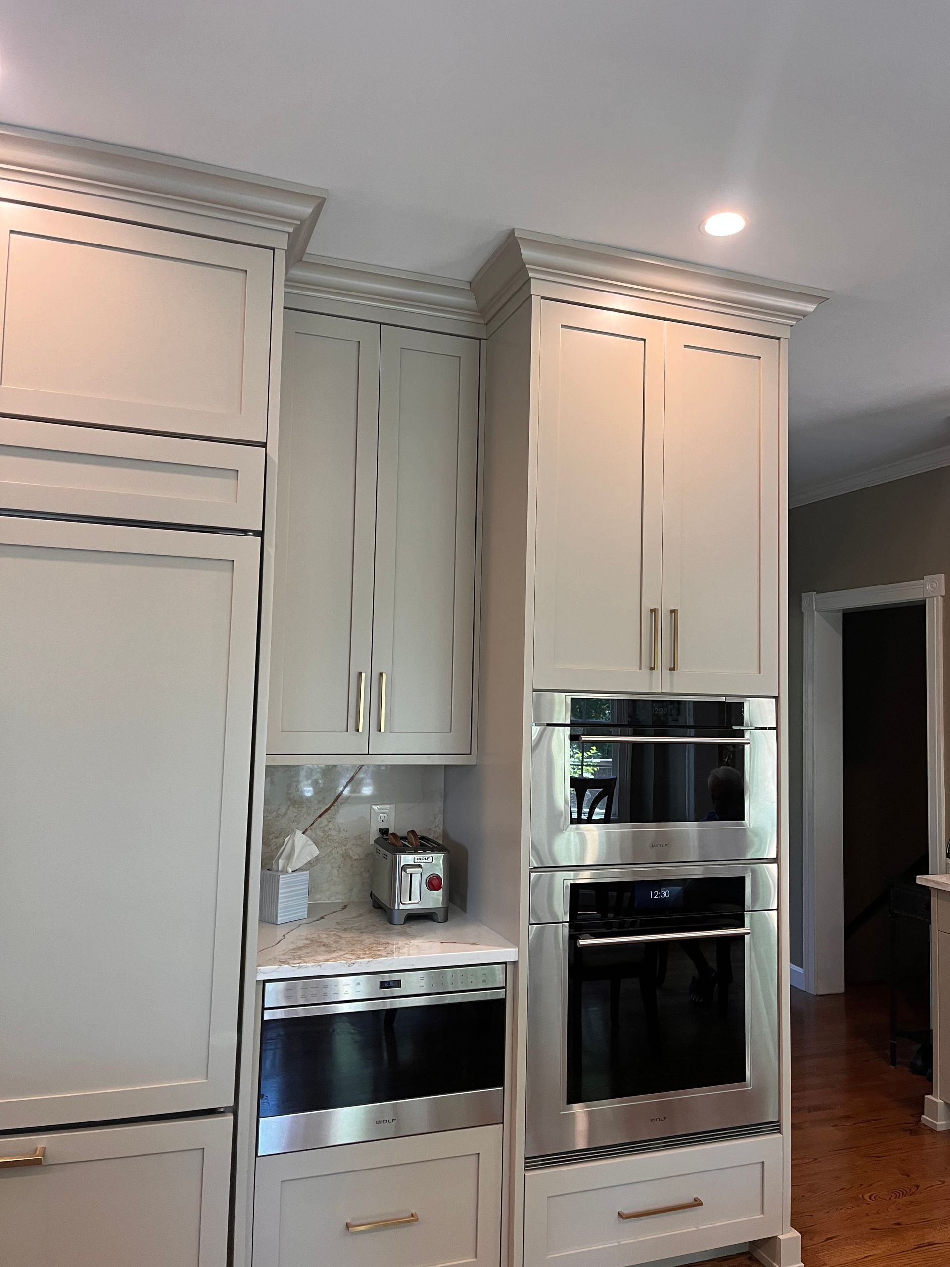 A kitchen with white cabinets and stainless steel appliances