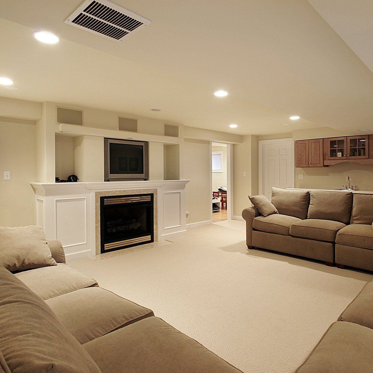 A living room with two couches and a fireplace