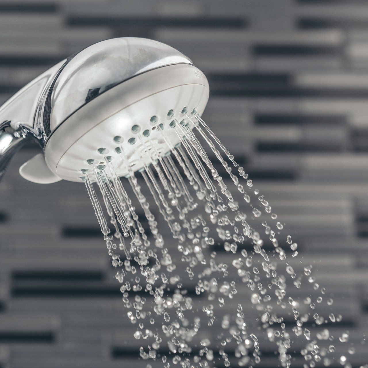 A shower head with water coming out of it