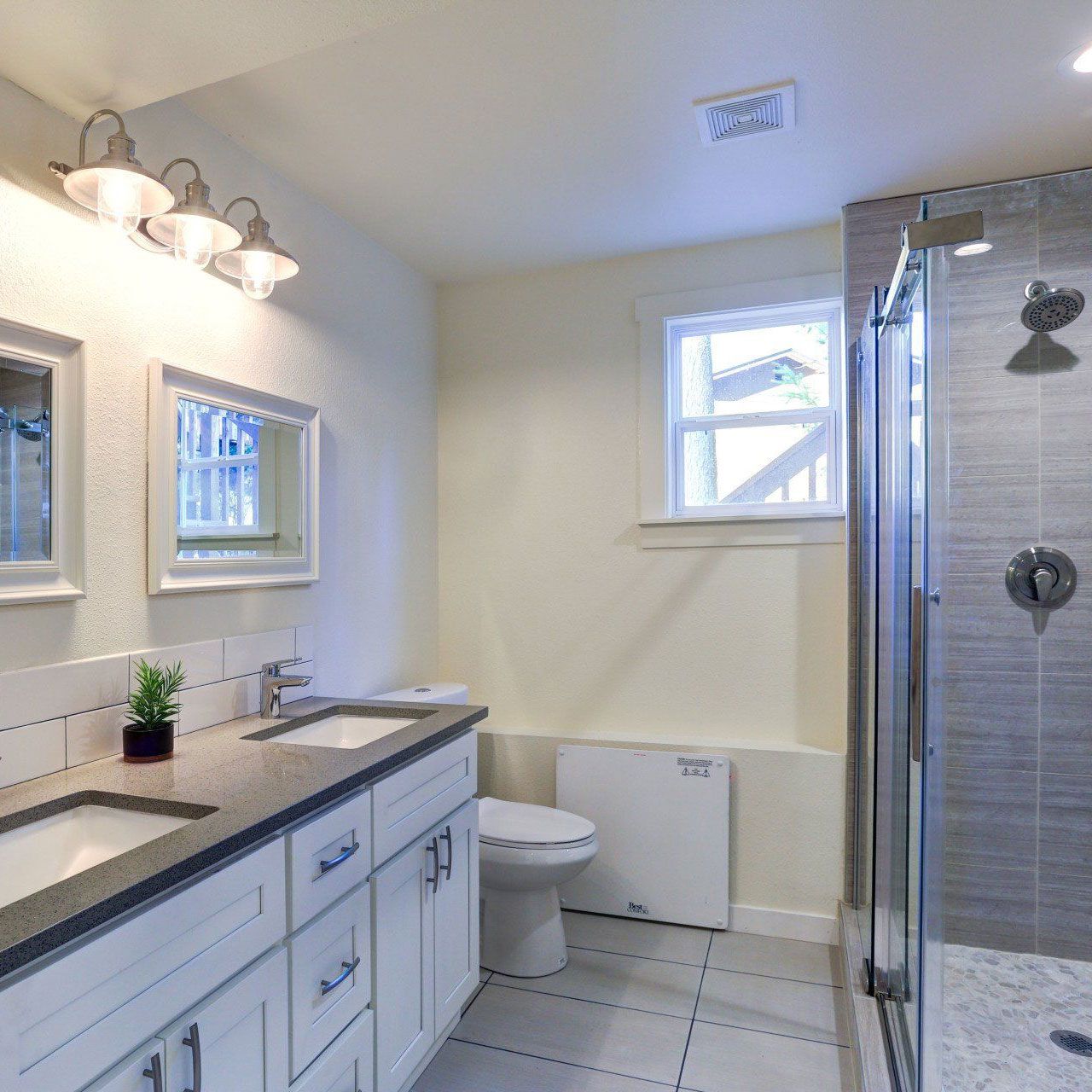 A bathroom with a toilet a sink and a shower