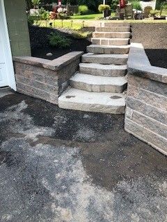A set of stairs leading up to a brick wall