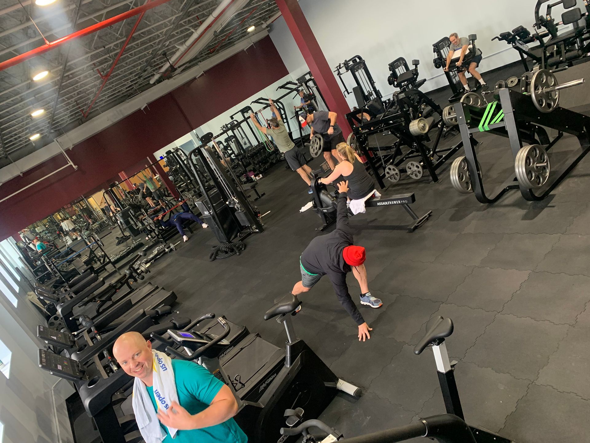 A group of people are doing exercises in a gym.