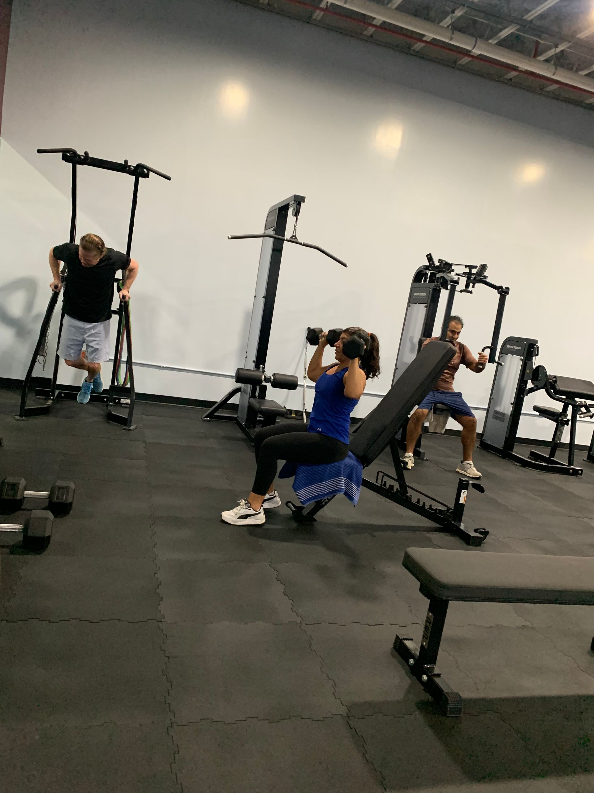 A group of people are working out in a gym.