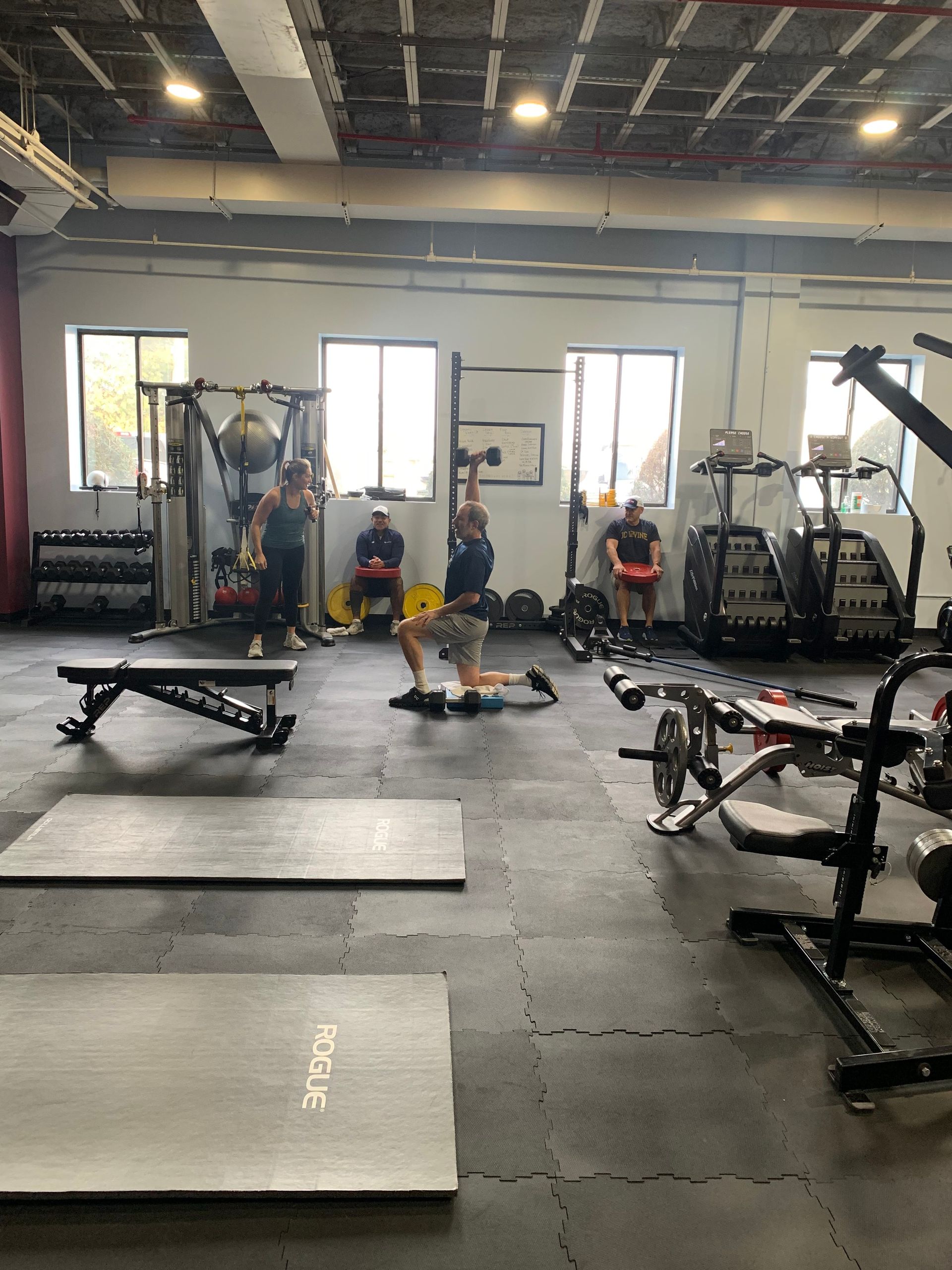 A group of people are working out in a gym.