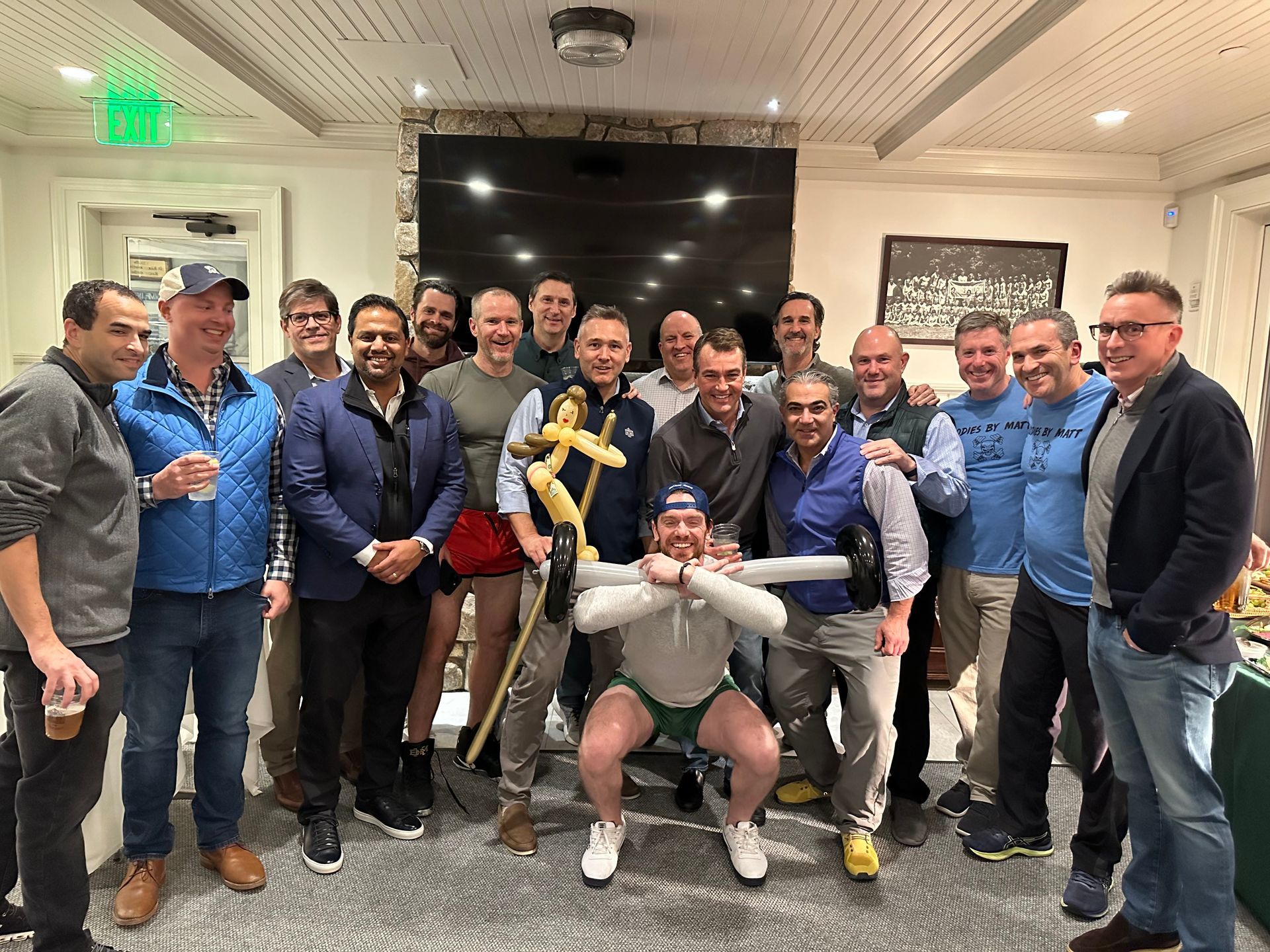 A group of men are posing for a picture in a room.