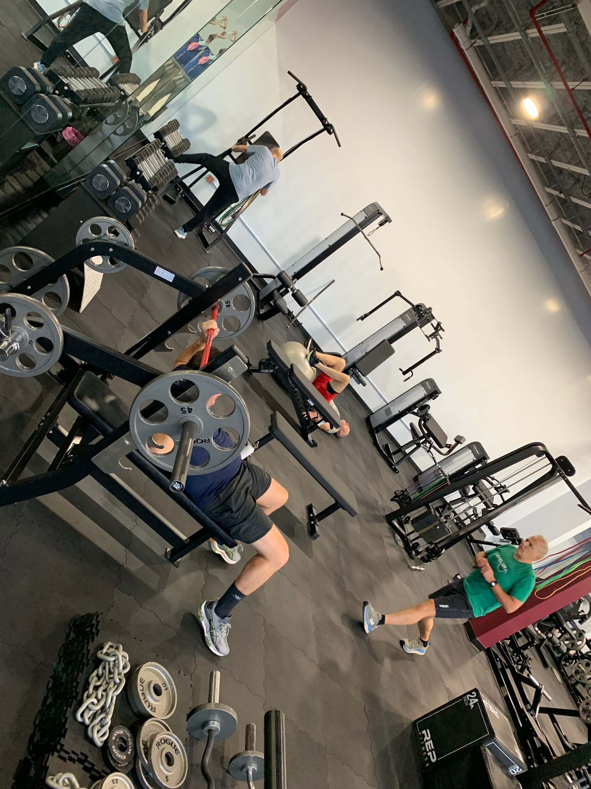 A group of people are working out in a gym.