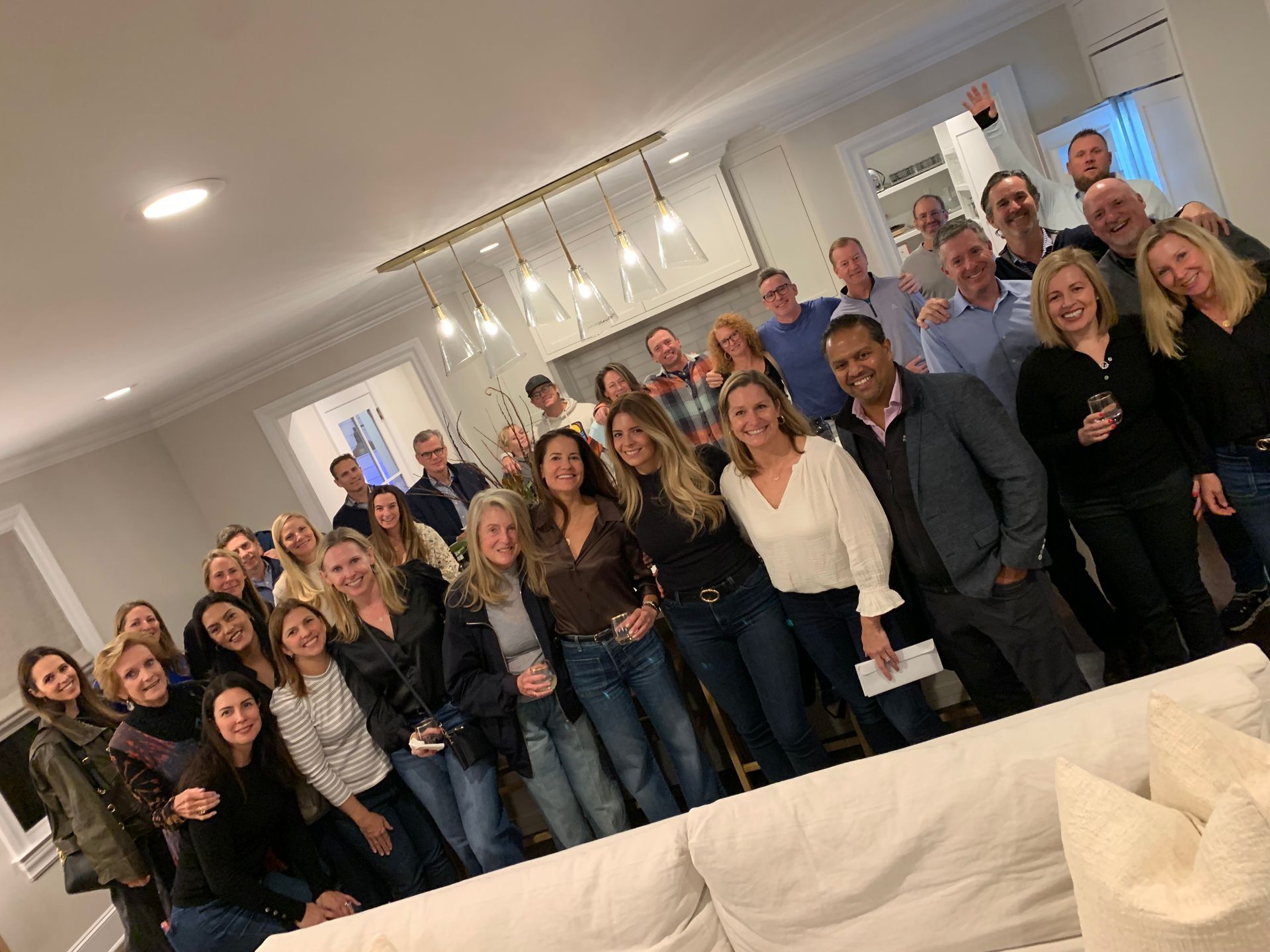 A group of people are posing for a picture in a living room.